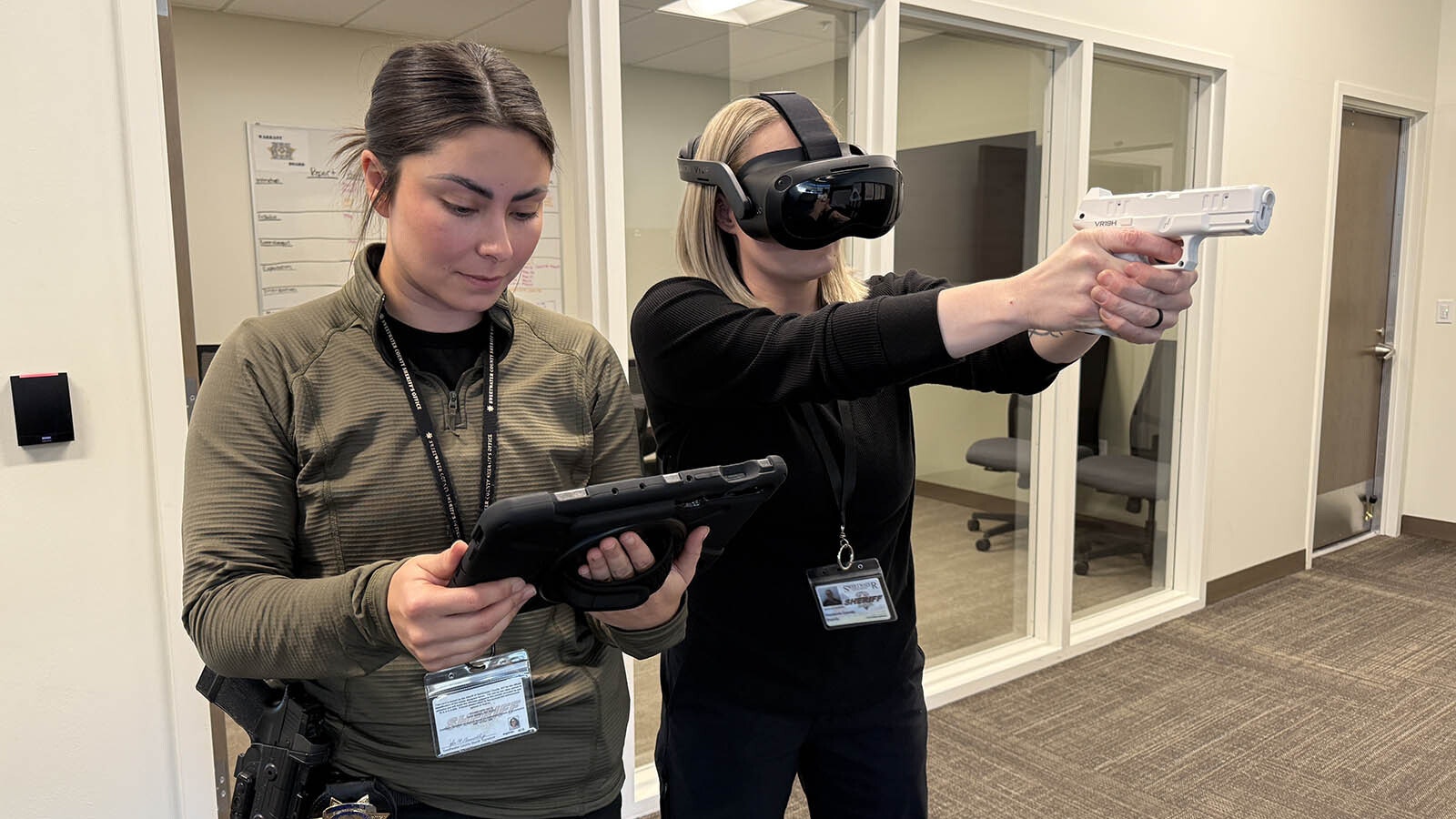 Detectives Ashley Merrell, left, and Stephanie Cassidy run through a virtual reality training program during a test of the technology at the Sweetwater County Sheriff's Office.