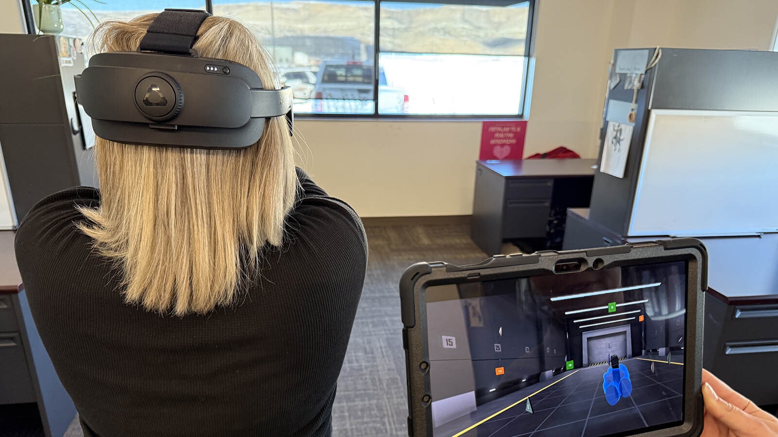 Detective Stephanie Cassidy runs through a virtual reality training program during a test of the technology at the Sweetwater County Sheriff's Office.