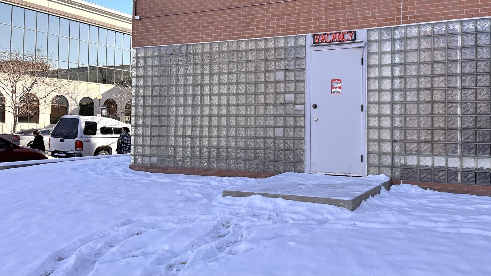 A motel-style "vacancy" sign flashes red over the north door of the Laramie County jail at the intersection of Pioneer Avenue and 20th Street in downtown Cheyenne.