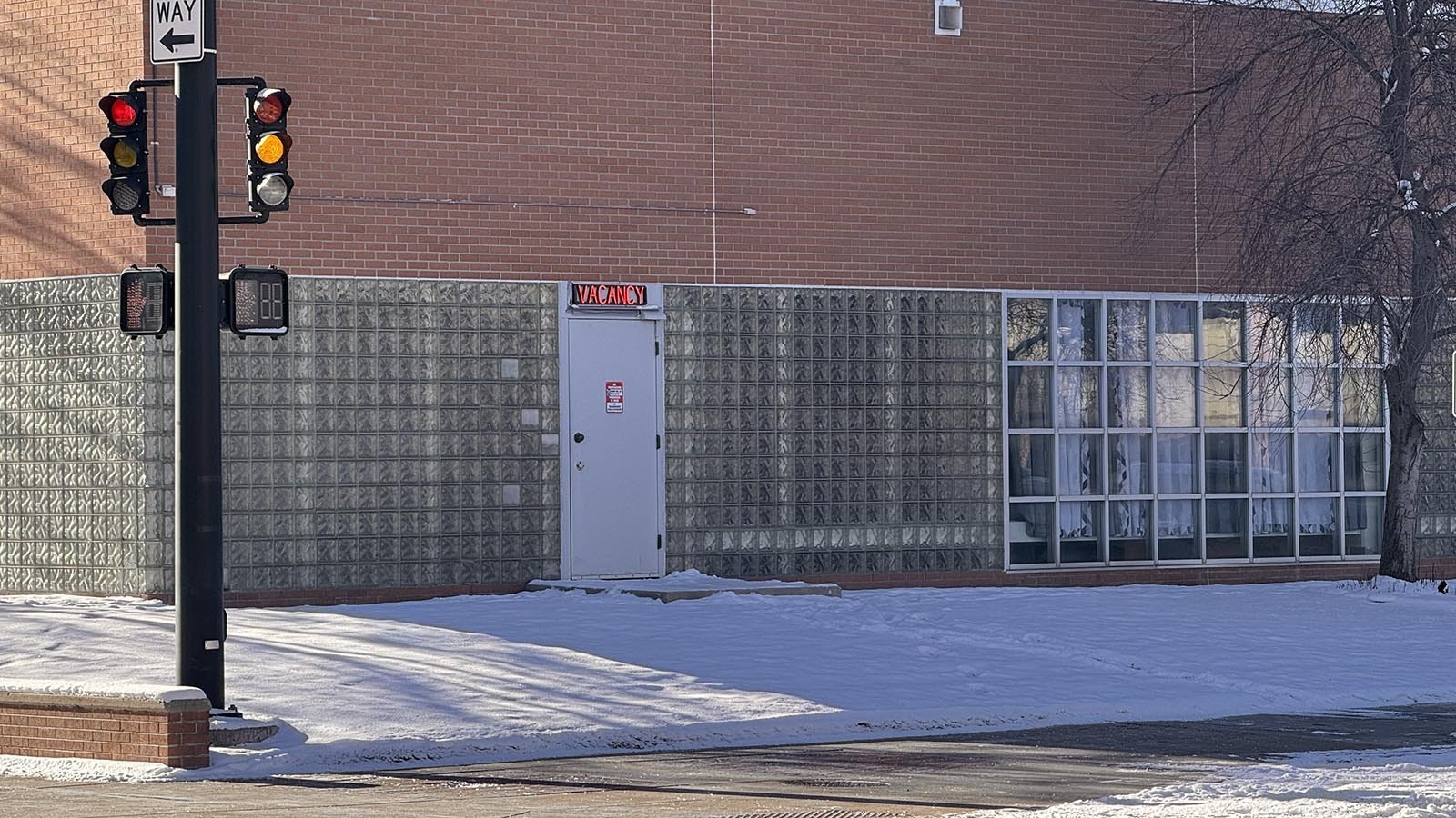 A motel-style "vacancy" sign flashes red over the north door of the Laramie County jail at the intersection of Pioneer Avenue and 20th Street in downtown Cheyenne.