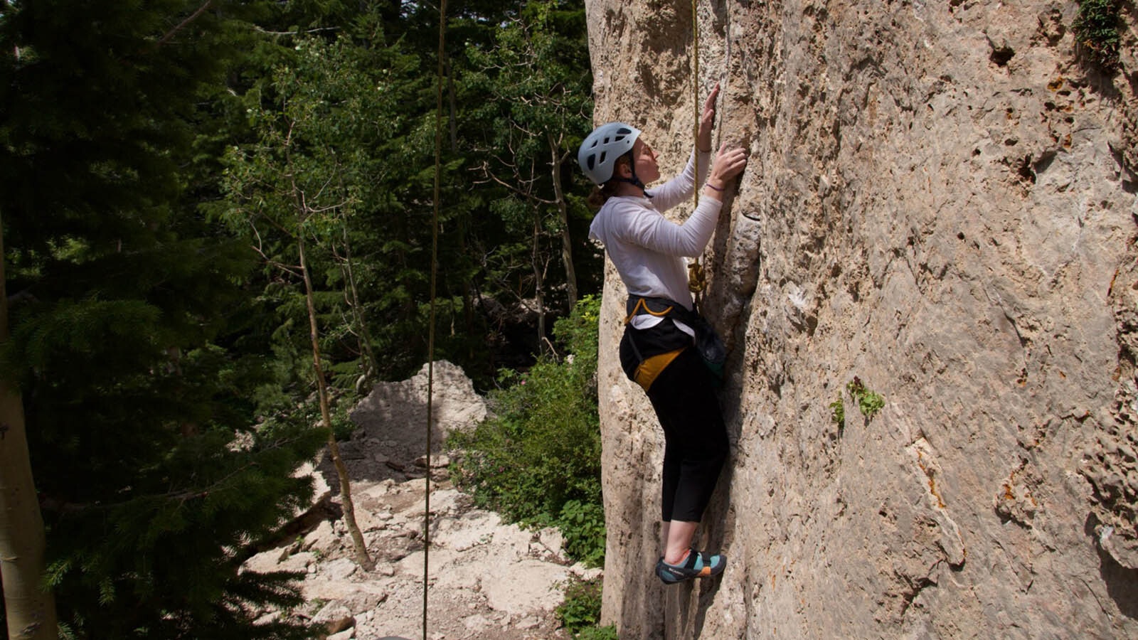 Sydnee Chapman rock climbs in Lander, Wyoming, in summer 2024 during her first week living out of a converted camper van.