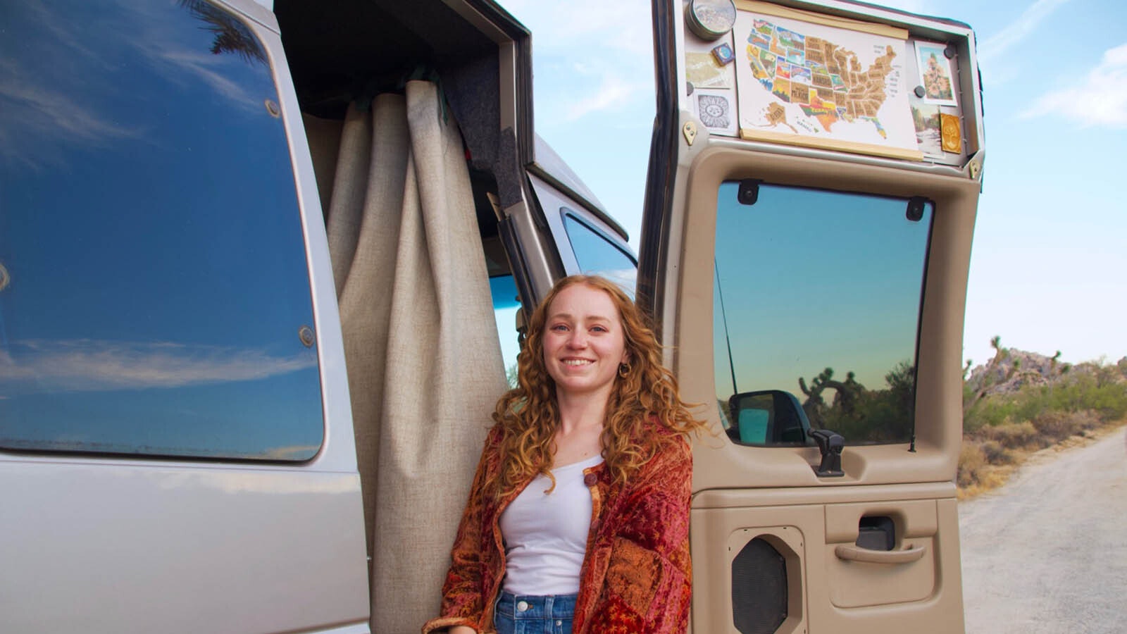 Sydnee Chapman poses for a photo outside her camper van in Joshua Tree National Park, California. Chapman has traveled through eight states since moving into the van earlier this summer.