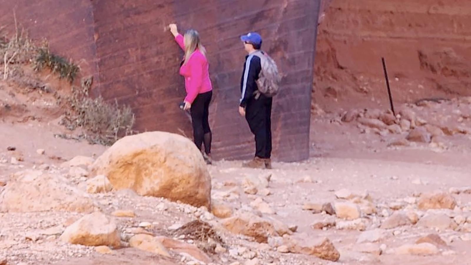 This woman, identified as Daniela Ganassim Erisen of Ivins, Utah, is shown on surveillance video vandlizing a petroglyph wall.