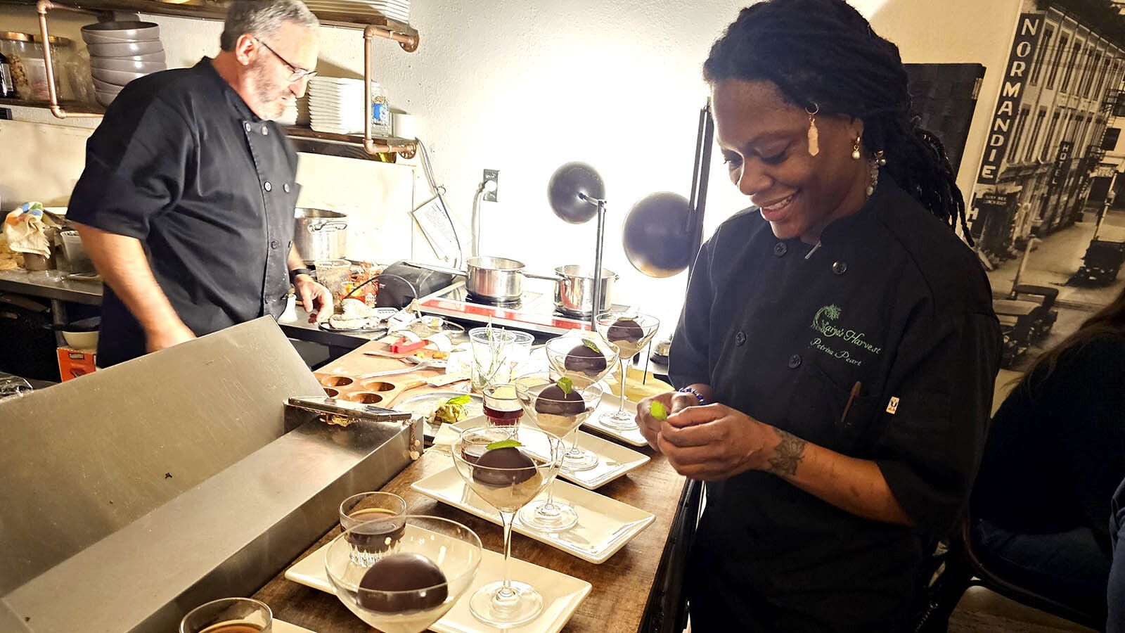 Chef Petrina Peart plating the final course of her seven-course, all vegetable dinner at Paramount Ballroom.