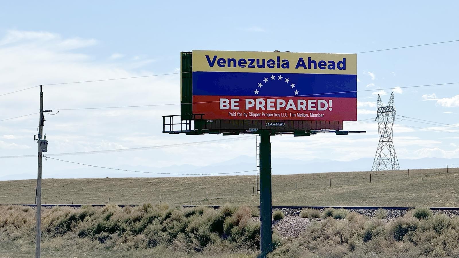 A large billboard designed like the Venezuelan flag warns drivers on southbound Interstate 25 as they enter Colorado that they're entering the South American country instead of the state.