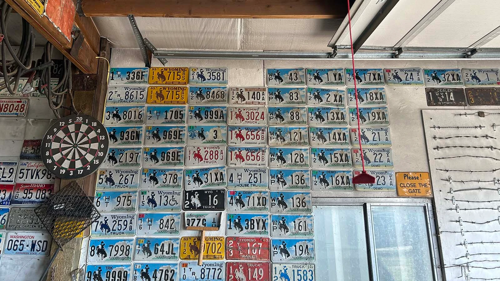 One corner of Vern Palmer's garage showcases an assortment of specialty Wyoming license plates, including dealer, demonstration and house trailer plates collected over decades. Palmer says every plate tells a story about the state's history. 