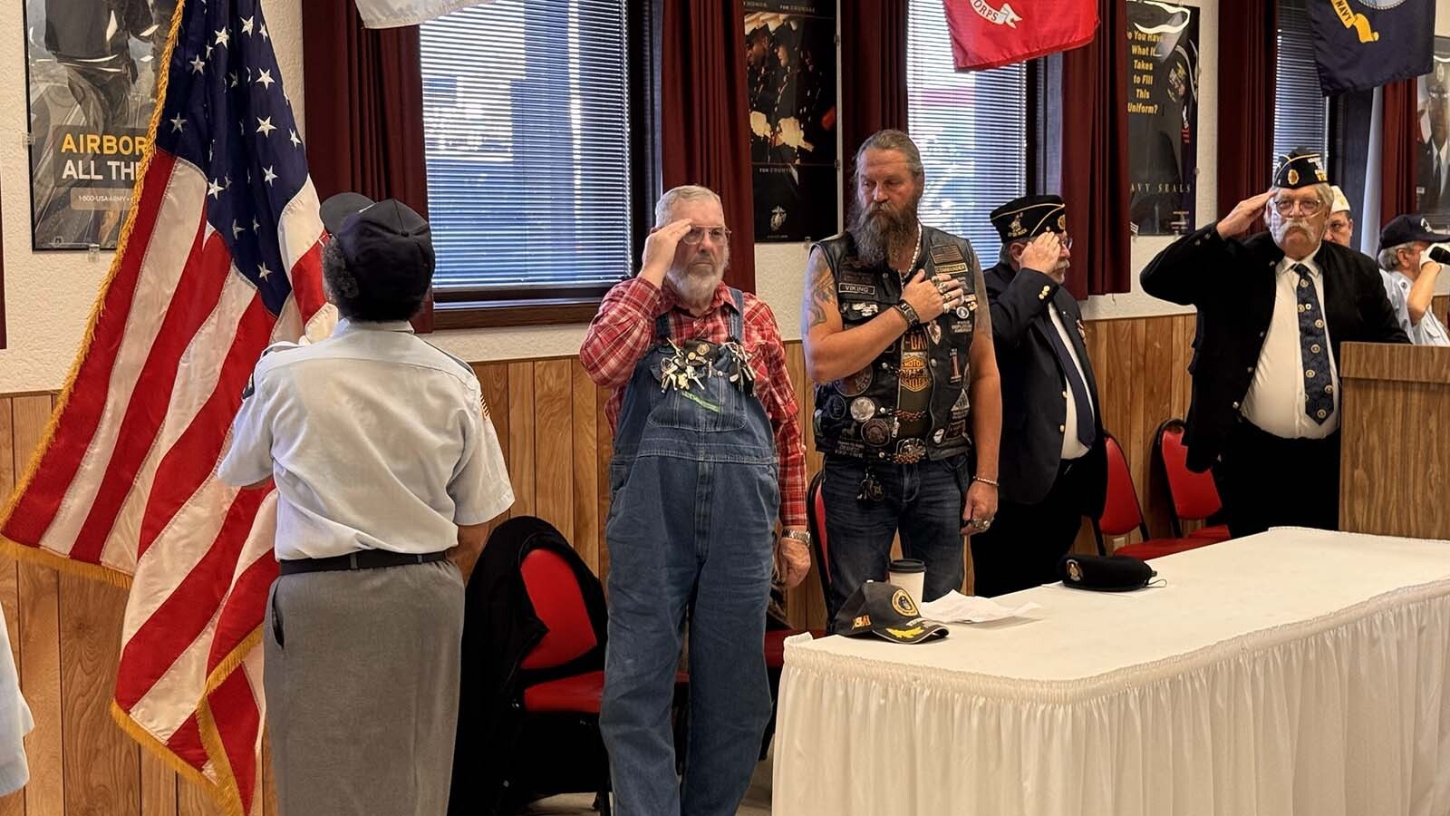 Mike Kent, from second left, and Rob "Viking" Larson, honor the American flag during Tuesday's Veterans Day ceremony at American Legion Post 6 in Cheyenne. At far right is post Commander Dwight Null.