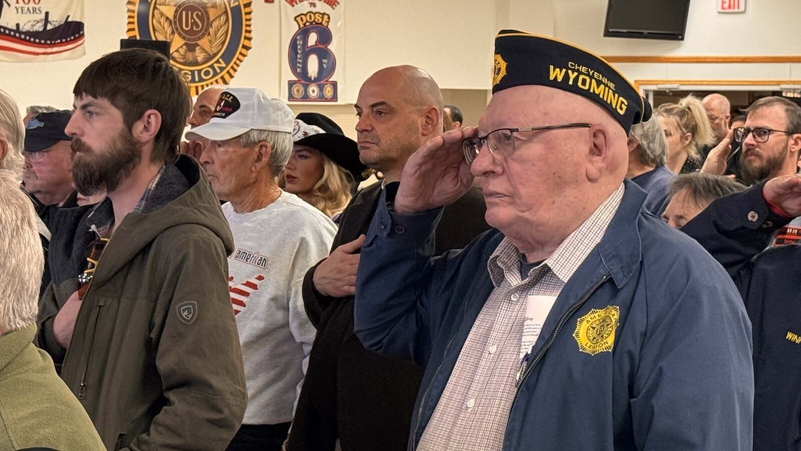 Tom Jurek salutes while the American flag is presented at American Legion Post 6 on Veterans Day, Nov. 11, 2025. He served in the Army from 1967-1970.