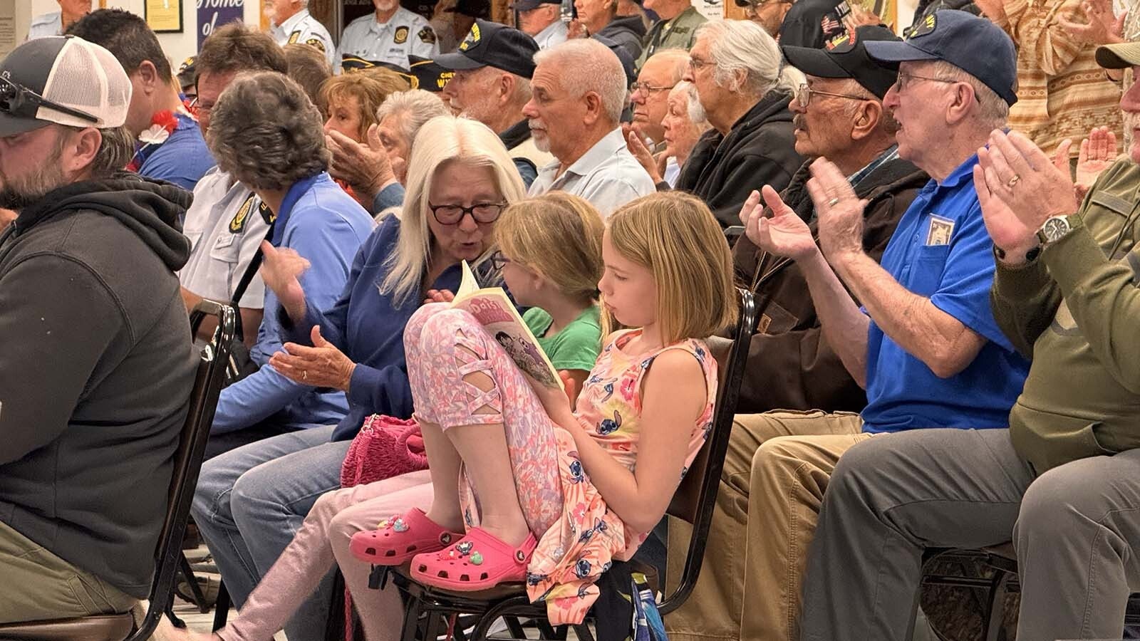 Sharon Grandpre talks with her granddaughters — Syudney Grandpre, 10, and Hailey Grandpre, 8 — at Tuesday's Veterans Day ceremony in Cheyenne.