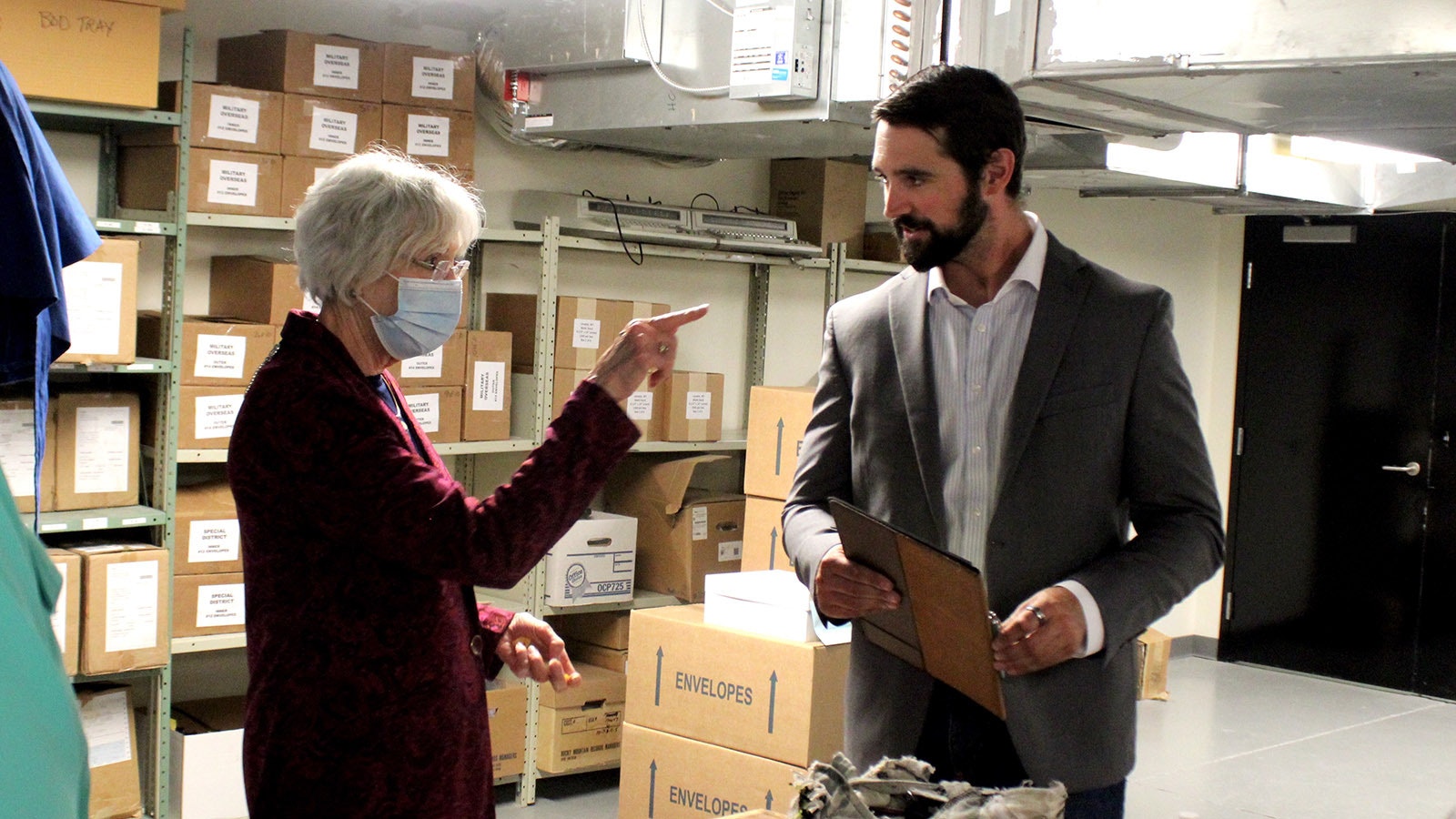 Laramie County Clerk Debra Lee, left, directs Cheyenne attorney Caleb Wilkins, who is part of a lawsuit suit suing Lee for original certification of the election equipment on Tuesday, Aug. 12, 2024.