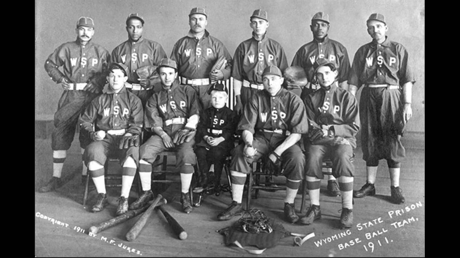A professional team photo of the Wyoming State Penitentiary All-Stars taken by prominent Rawlins photographer M.F. Jukes.