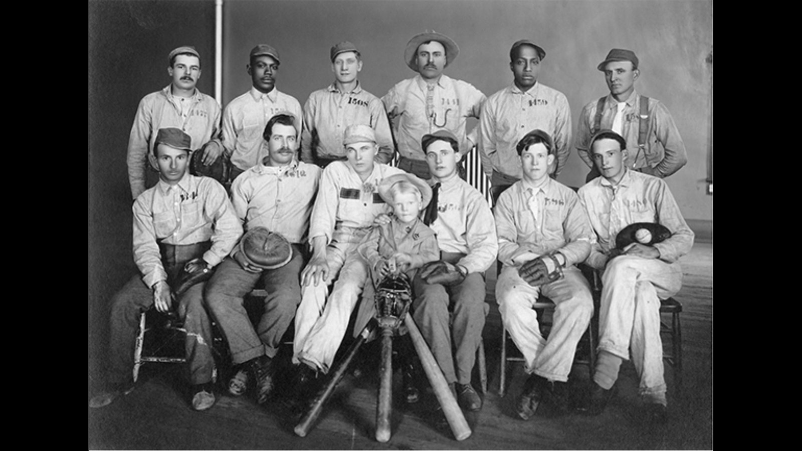 Team photo of the original Wyoming State Prison All-Stars prior to getting uniforms. The kid in the middle is the warden's 4-year-old son.