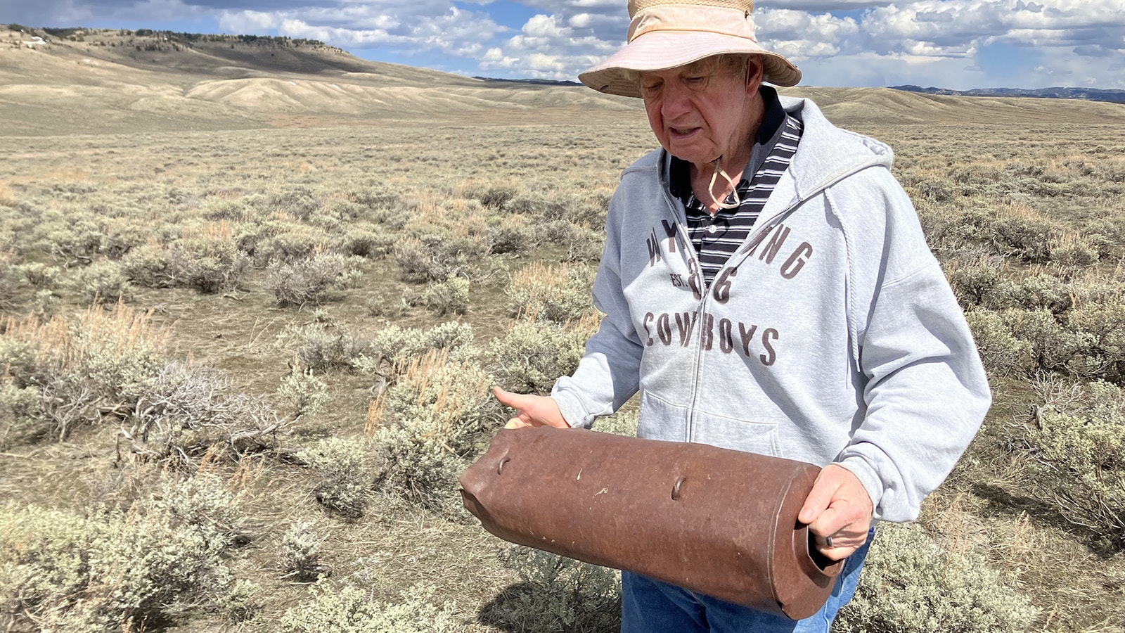 Mark Milliken of Casper holds a practice bomb that was on the B-24 when it crashed. It was found along the plane’s skid path.
