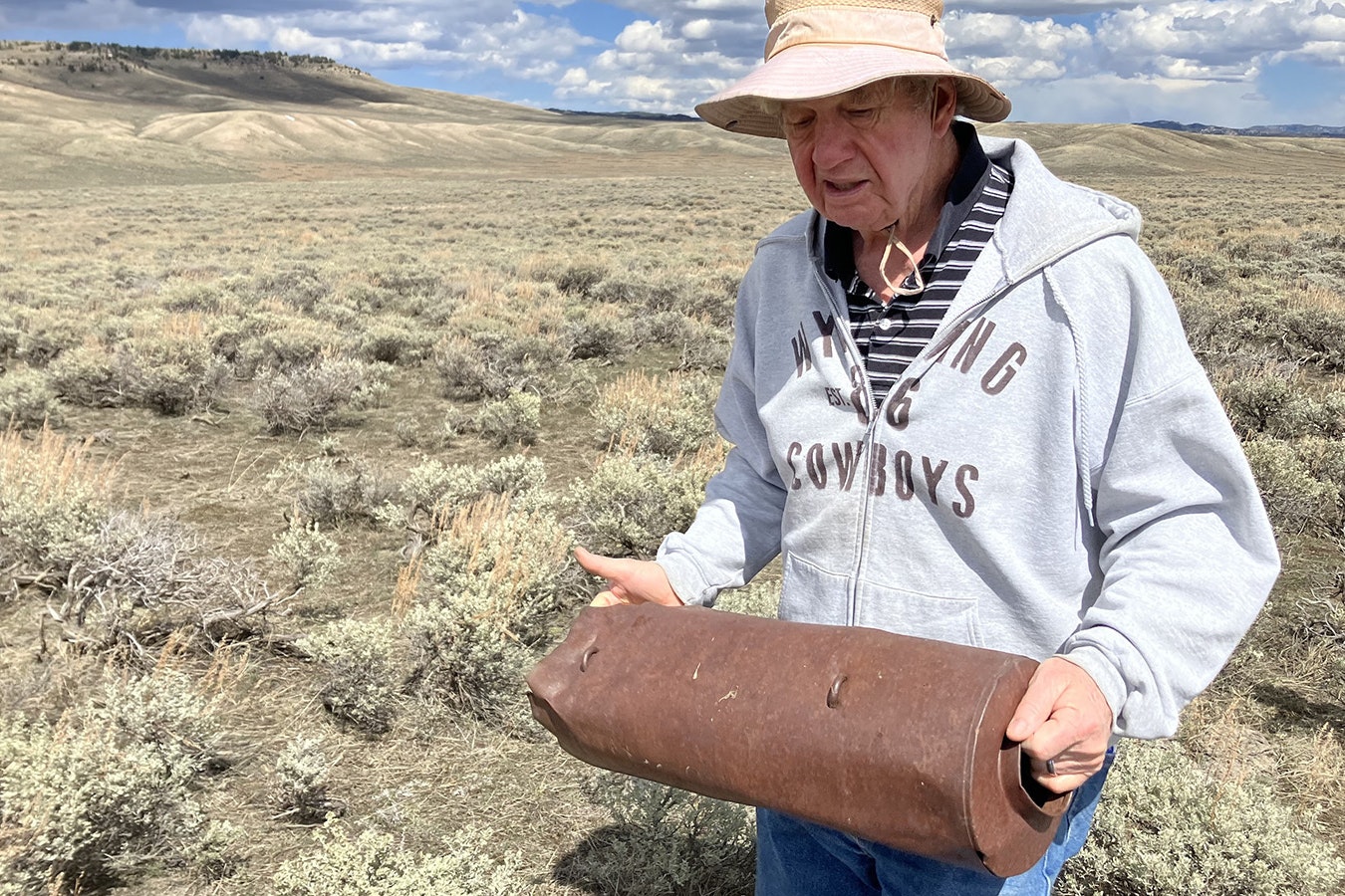 Mark Milliken of Casper holds a practice bomb that was on the B-24 when it crashed. It was found along the plane’s skid path.