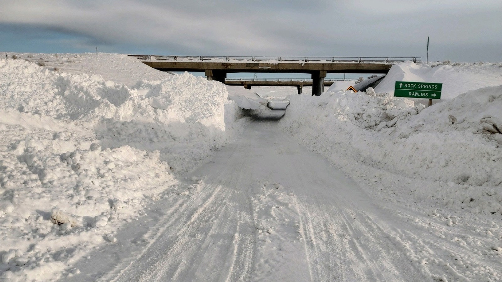 With snow nearly to the top of an Interstate 80 overpass, plow drivers basically had to cut a tunnel under the highway.