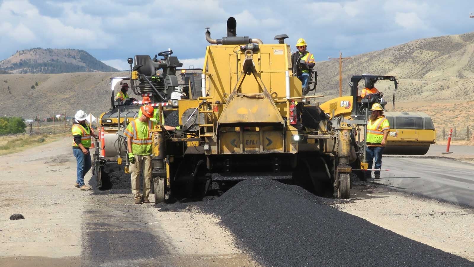 Wyoming Department of Transportation's director says the previously reported $400 million deficit in the department is closer to $600 million now. Lawmakers say solving the problem is no easy feat. Avove, a work crew paves a 5-mile section of Highway 26/287 near Dubois in fall 2025.