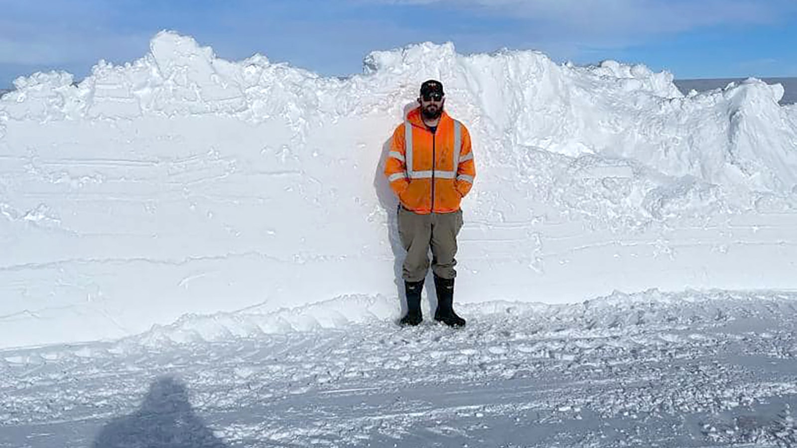 A Wyoming Department of Transportation worker stands next to a plowed road near Riverton, Wyoming, to show how much show had fallen during a storm this past winter. As the agency says on its Facebook page, the worker is not a short person.