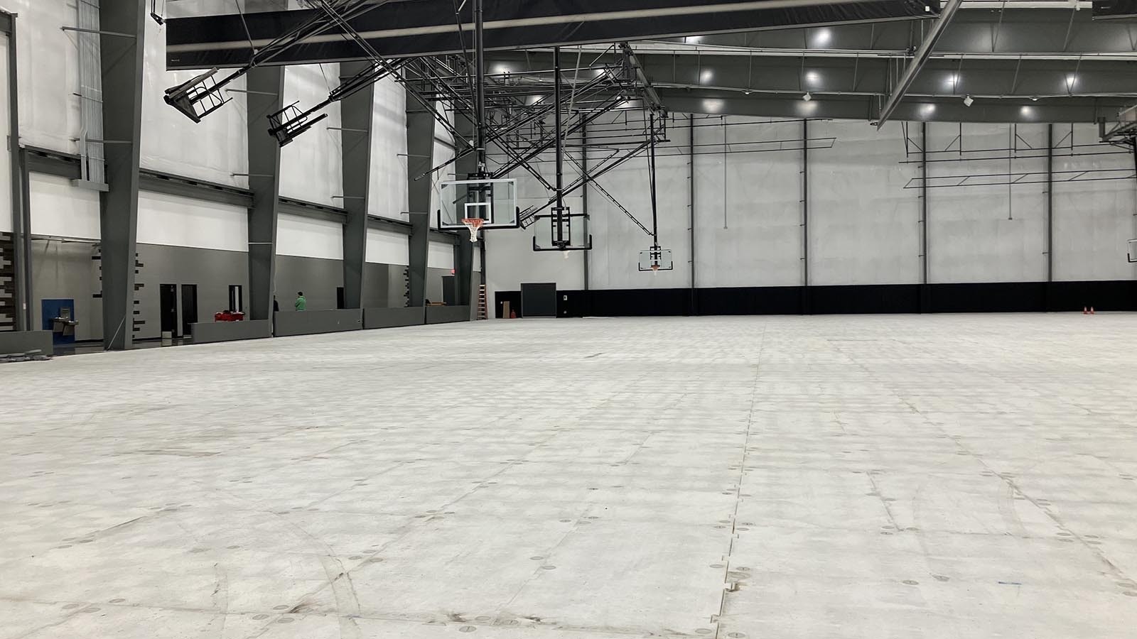 The large turf area on the west side of the Wyo Sports Ranch can be covered and converted to court space. The portable court surface has not yet arrived. A subfloor sits on top of the turf.