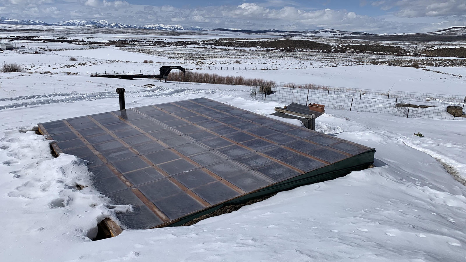 A south-facing roof made of polycarbonates like those used for greenhouses seals the walipini from the outdoors.