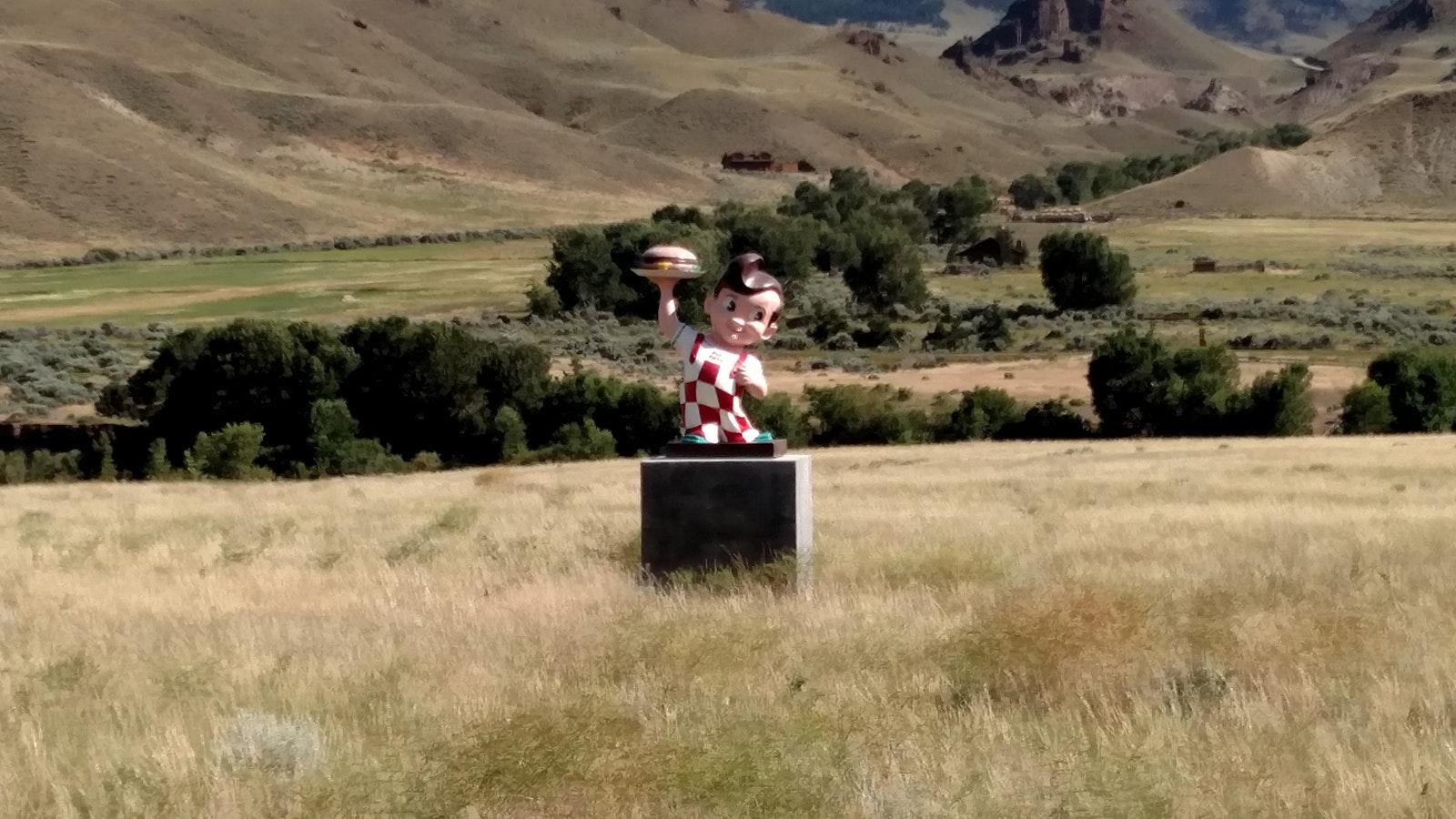 Big Boy stands alone in a field on a cement pedestal about 20 miles west of Cody along U.S. 14/16/20 on the way to and front the East Entrance of Yellowstone National Park.