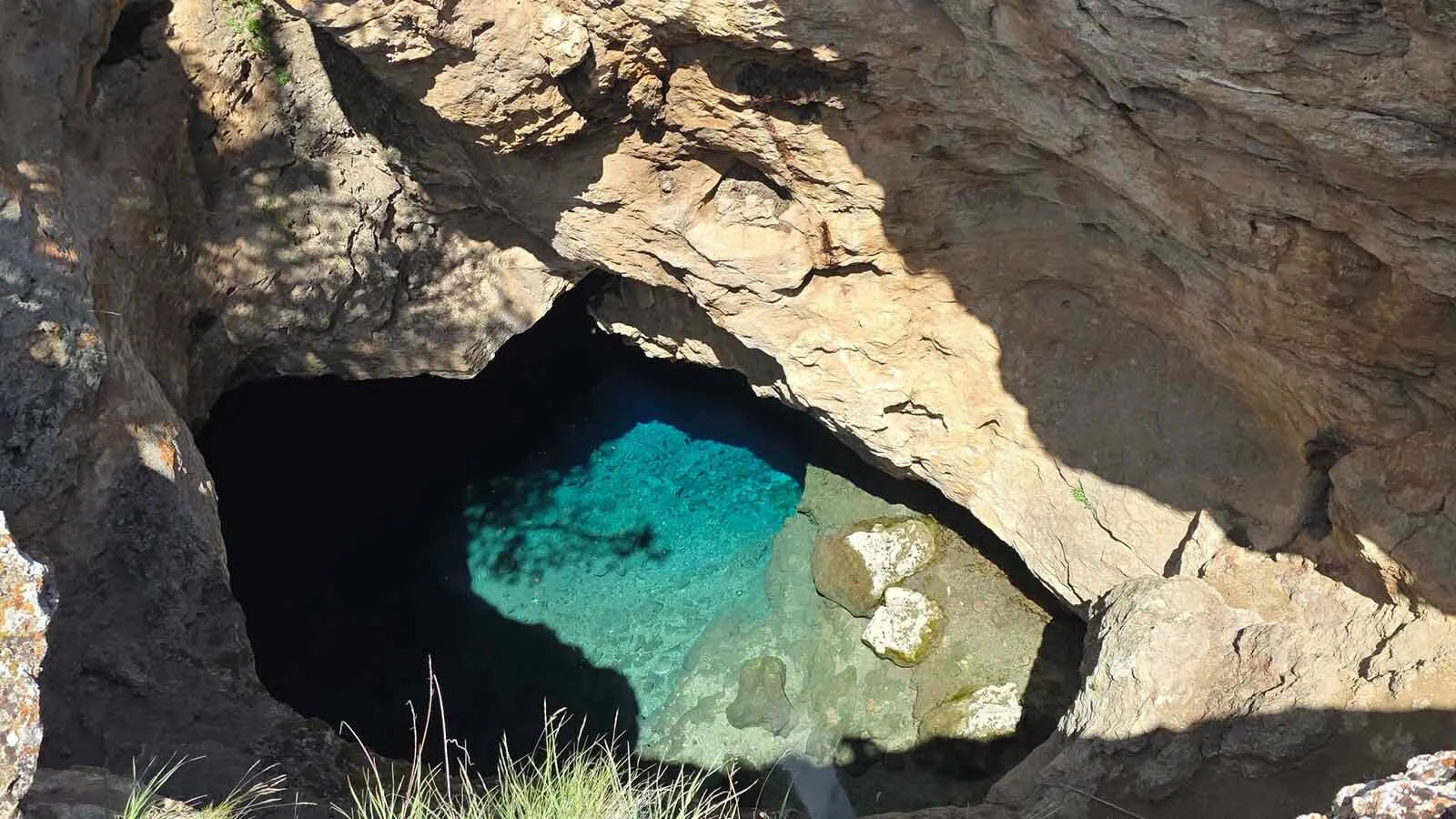 Warm Spring Geyser is a pool of brilliantly blue thermal water hidden in a cavern near Dubois, described by a frequent visitor as "like something you find down in the Caribbean.” The trick is getting there and whether to risk descending into it.