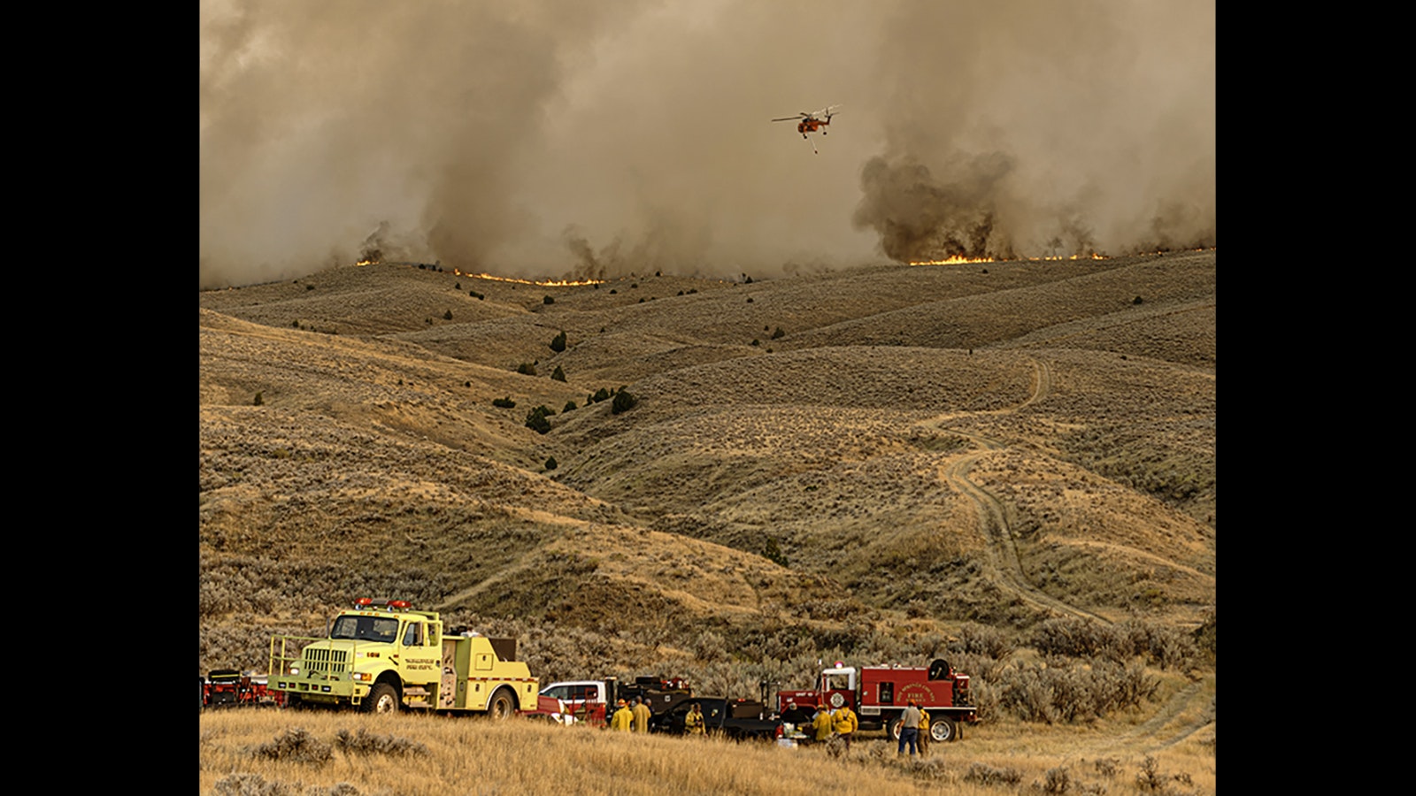 Firefighters continue to battle the Warm Springs Fire about 5 miles southeast of Thermopolis, Wyoming.