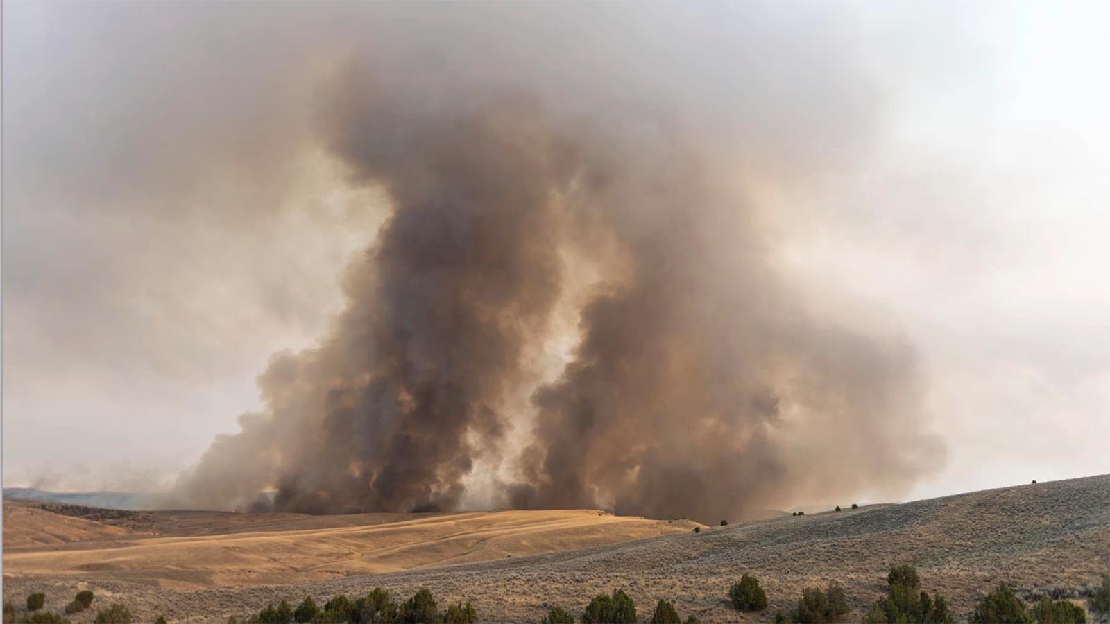 Smoke rises from the Warm Springs Fire.