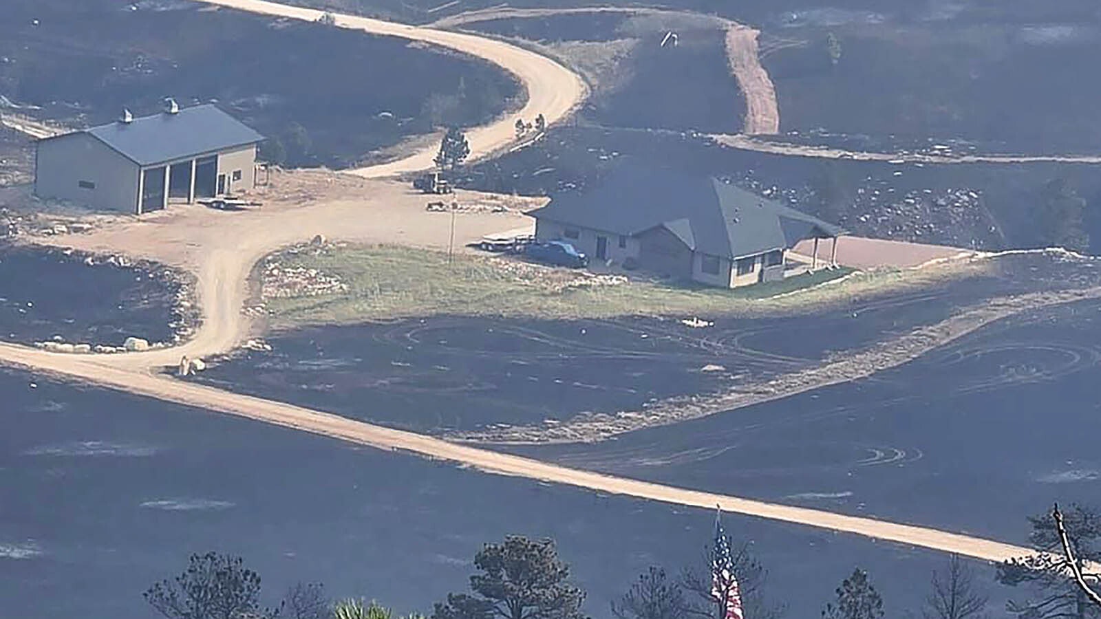 The Elk Fire rages around Warren Titschler's home near Dayton, Wyoming. With a hose and a water tank, he protected it through a frightening night of out-of-control wildfire activity.