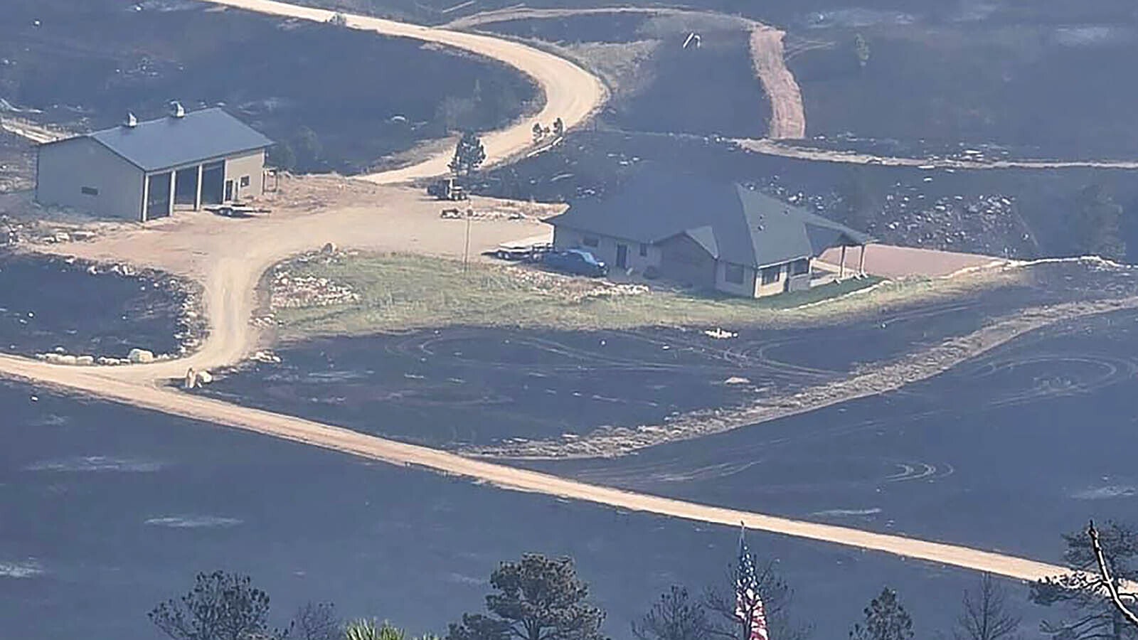 Warren Titschler's home after the Elk Fire roared into the Horseshoe Subdivision in 2024. Firefiighters saved the buildings, but all the vegetation was burned.