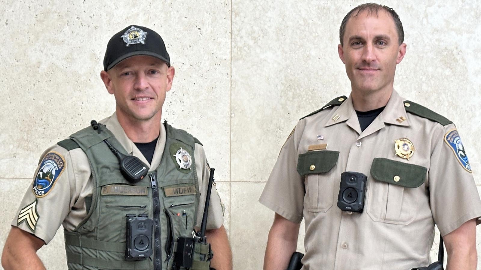 A pair of Washington state game wardens wear body cameras, which all of the state's game wardens will be required to wear starting next month.