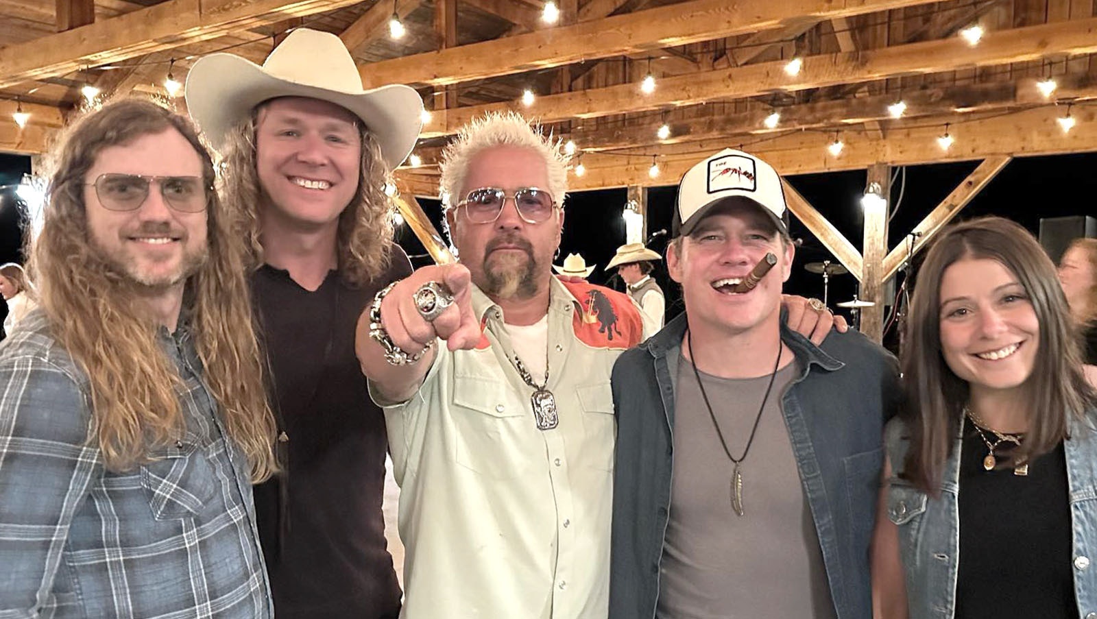Country-rock artists Wayland The Band pose with Food Network star Guy Fieri during a recent visit to the TA Ranch in Buffalo, Wyoming.