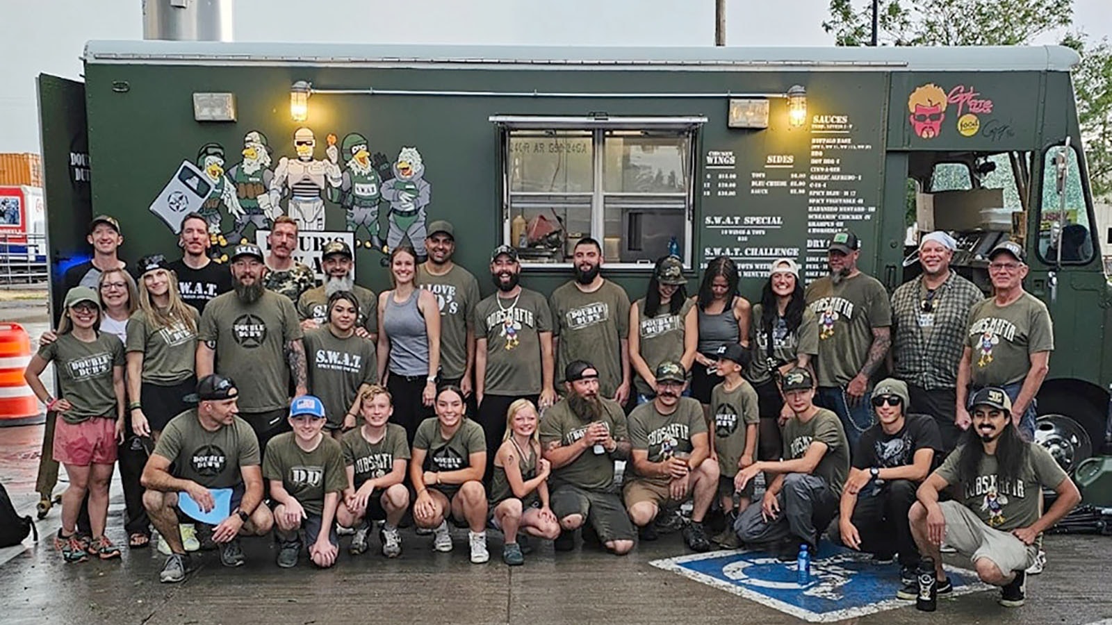 The Weitzels Wings team poses for a photo in front of one of the four food trucks they brought to Cheyenne to smash two world records for selling buffalo wings.