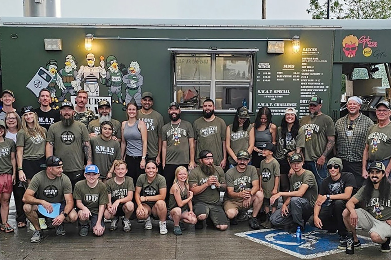 The Weitzels Wings team poses for a photo in front of one of the four food trucks they brought to Cheyenne to smash two world records for selling buffalo wings.