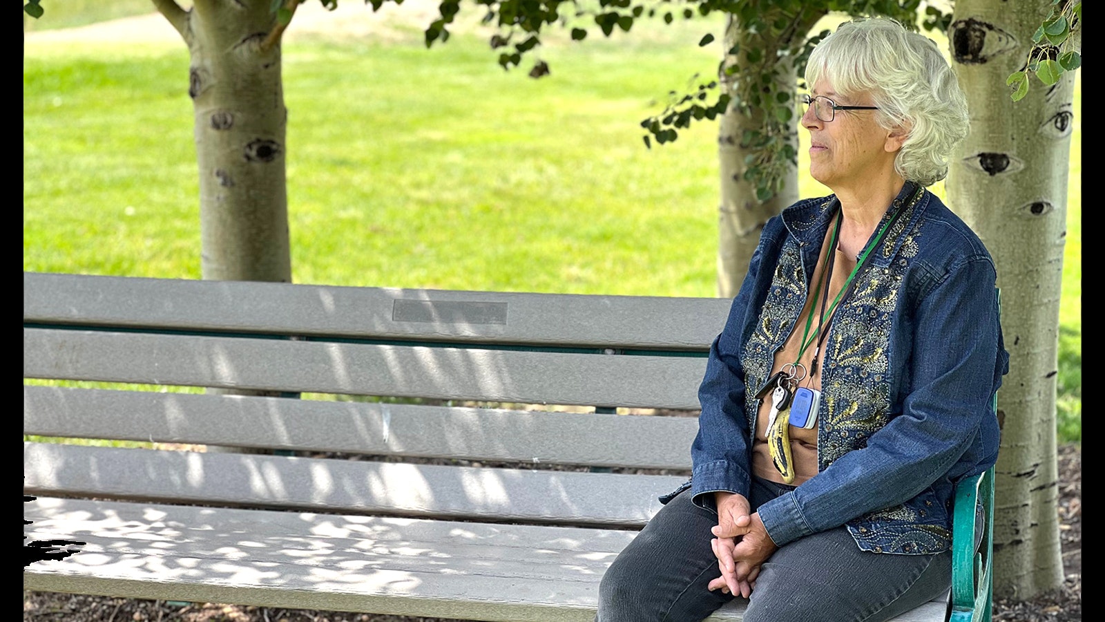 Wendy Bidstrup sits on a bench in the park area across the street from her home in Laramie where she met David Leyba.