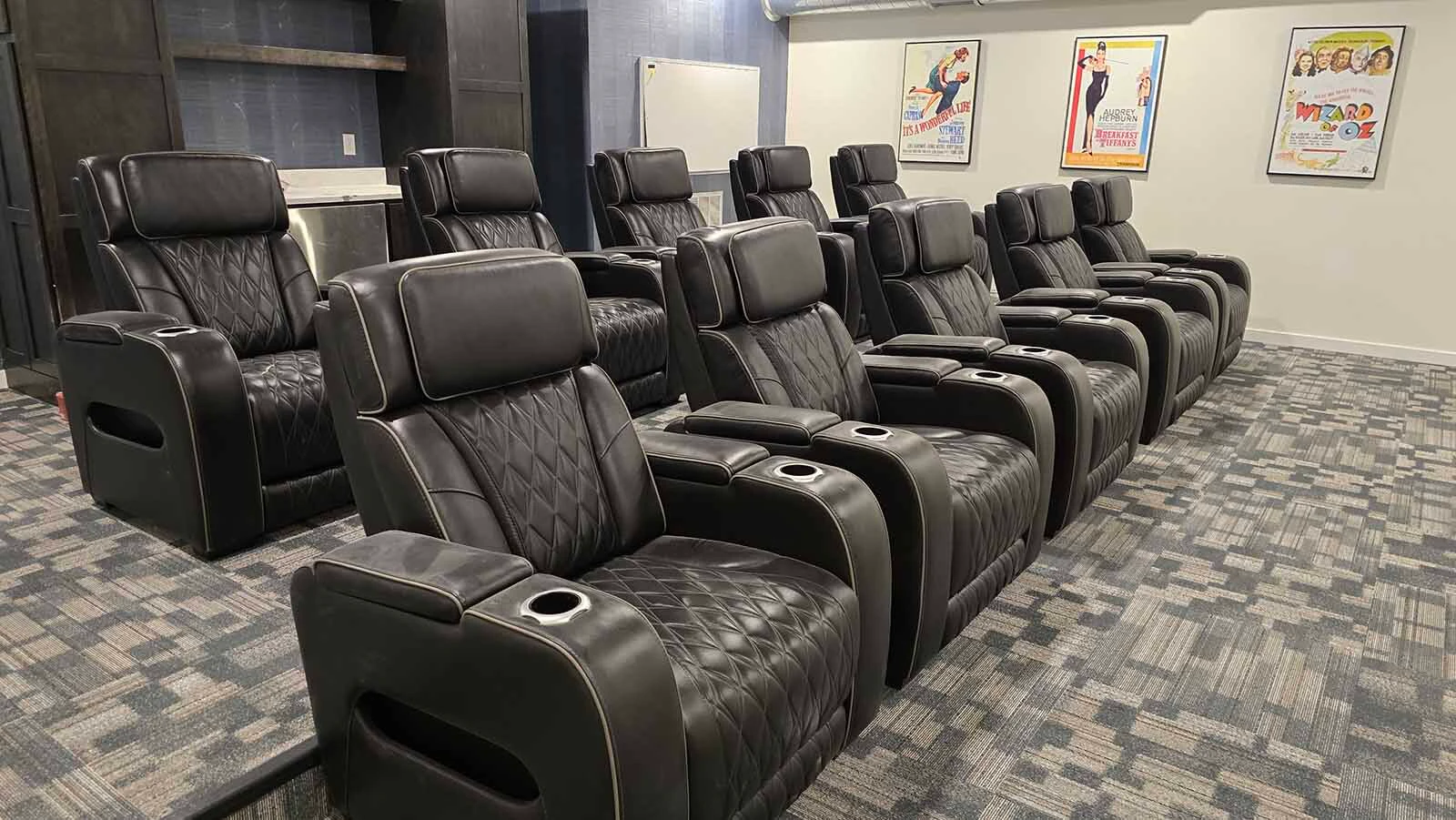 A fleet of massage chairs in the theater lounge at The Aire. The lounge is free for the use of its tenants.