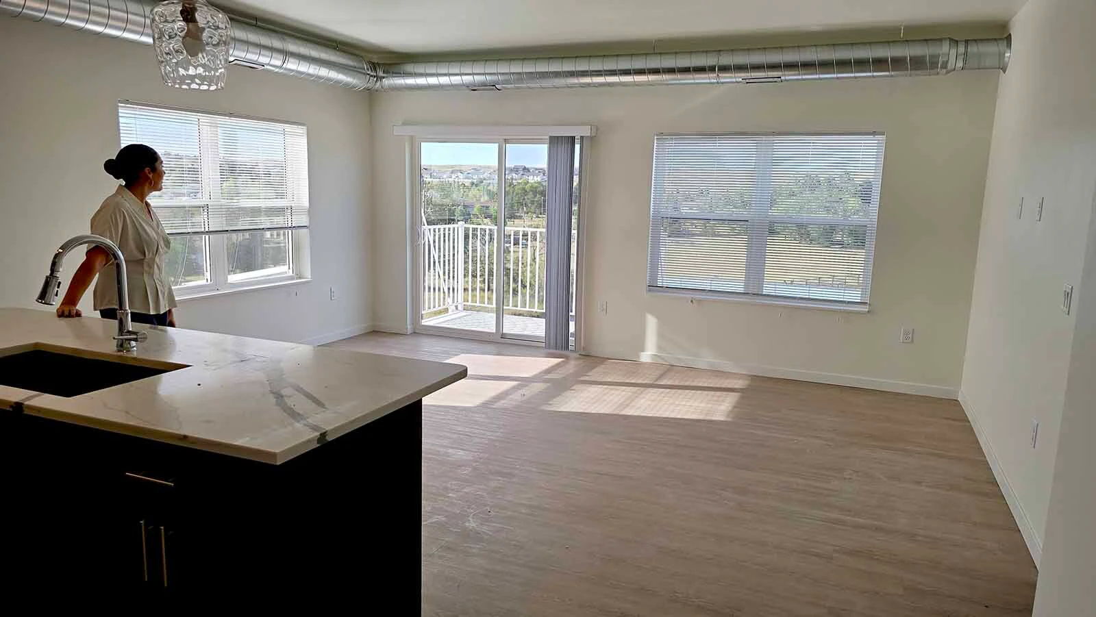 Property manager Alana Skorupski looks out the windows in a two-bedroom apartment at The aire.