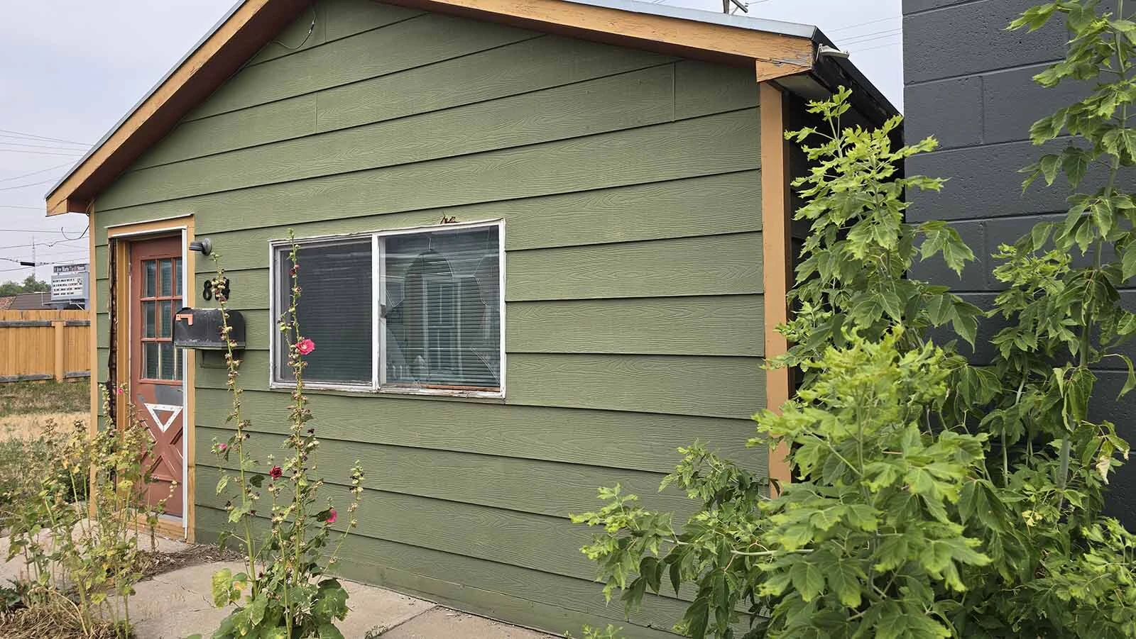 From the front, this green cottage looks tiny. Its future occupants include a jewelry store.