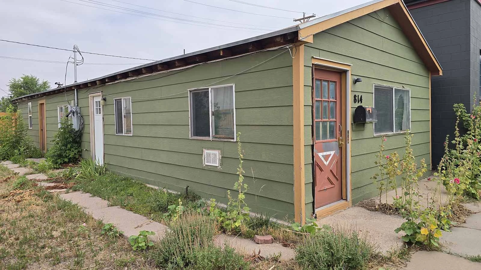 While the green cottage looks tiny from the front, it has a long side, giving it a 1,000-square-foot footprint.