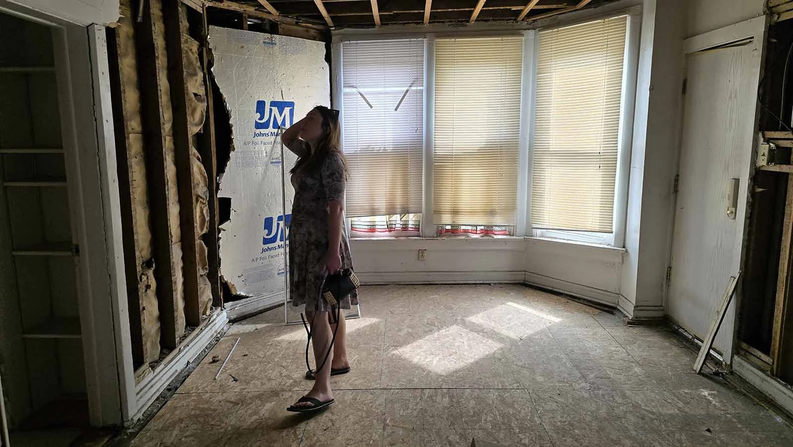Molly Lyle stands in the area where a curved window creates what could be a charming dining nook in the future bakery.