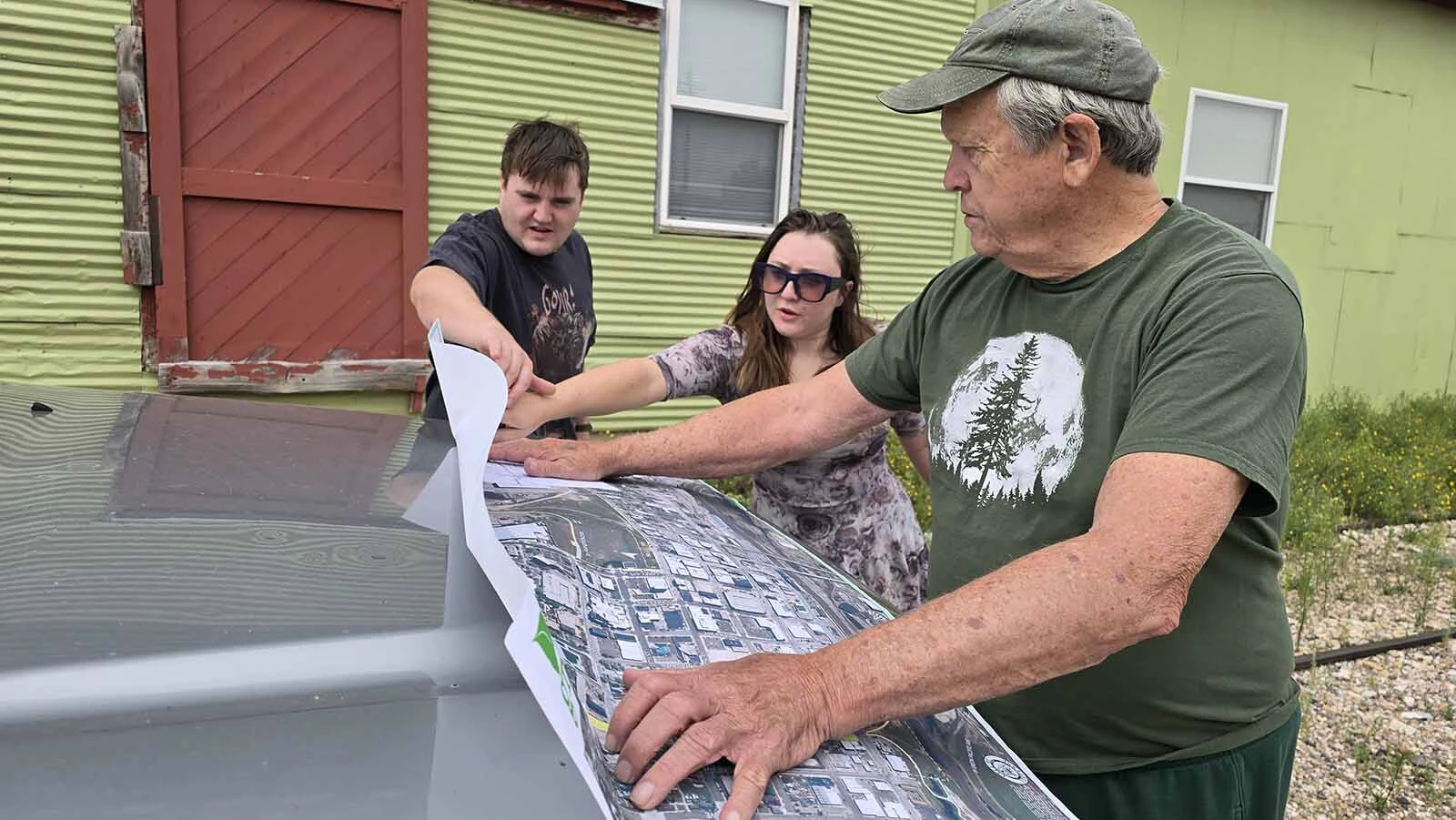 Cheyenne City Councilman Pete Laybourn, front, shows the Lyle family another map of the Reed Avenue Corridor project, while Jason and Molly Lyle look on. Sherrie Lyle is present but not pictured.