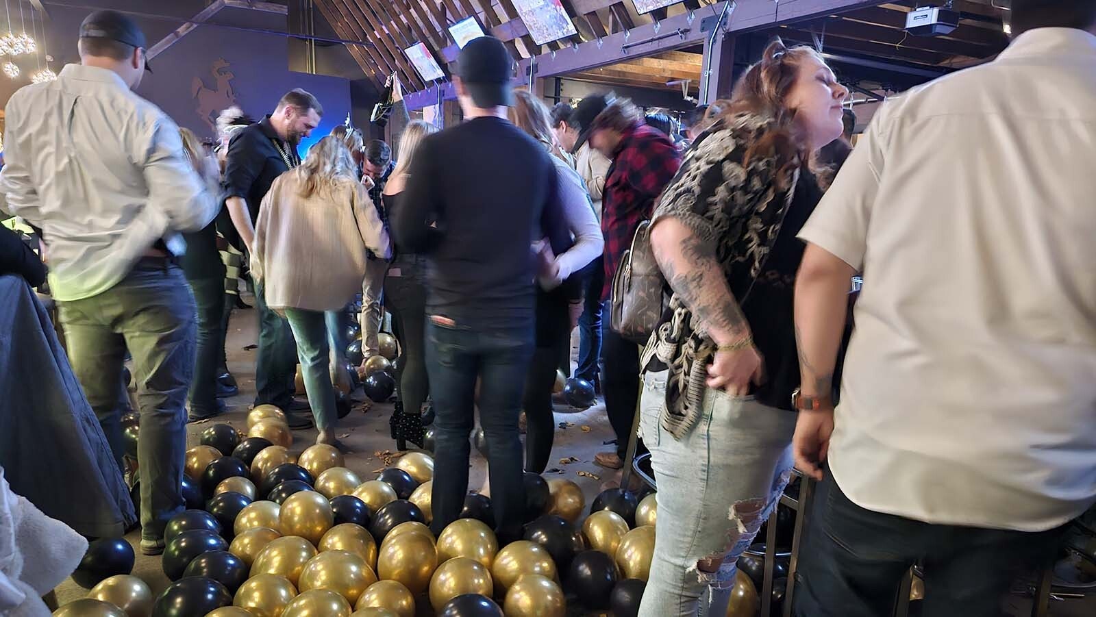 Shortly after midnight on New Year's Eve, people stomp on balloons that have just been dropped at Westby Edge Brewing Company.