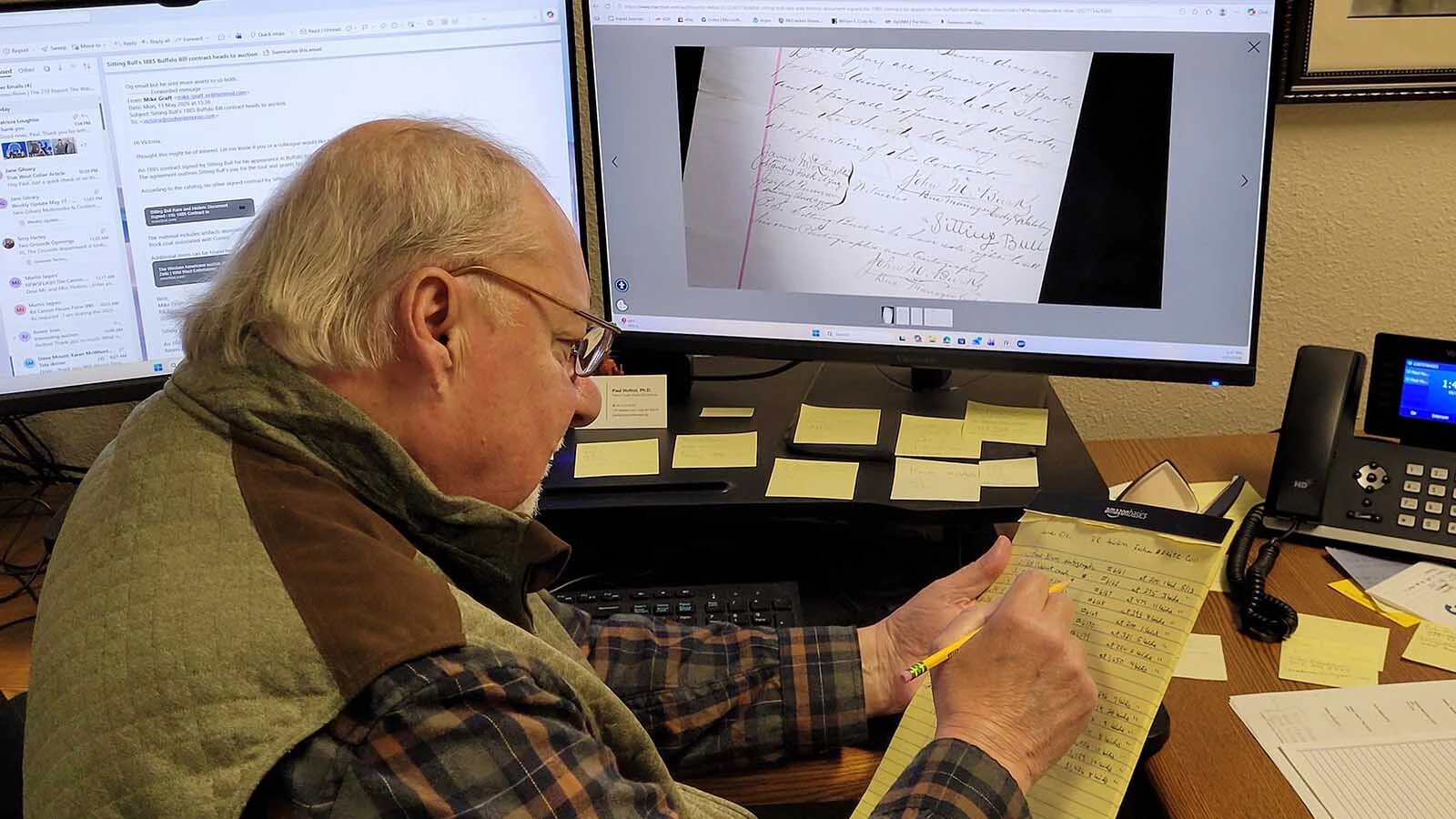Paul Hutton looking over items in the auction, and trying to decide if the Buffalo Bill Center of the West will bid on anything.
