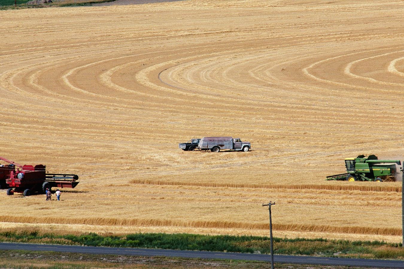 Combines work to harvest wheat in a Laramie County field near Cheyenne.