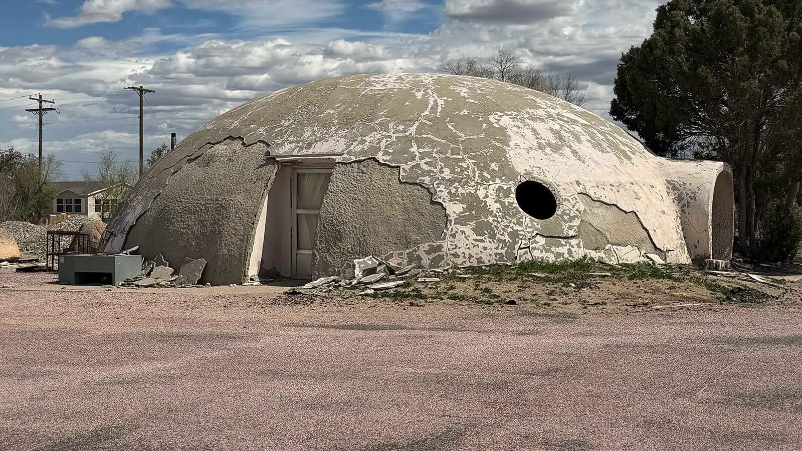 Cracked and weatherworn beside South Street in Wheatland, the strange concrete dome looks more like a stranded UFO than the old Wyoming DMV it once was.