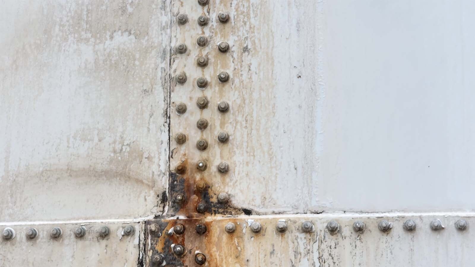 Close-up of failing and leaking rivets on a 1 million-gallon water tower in Wheatland.