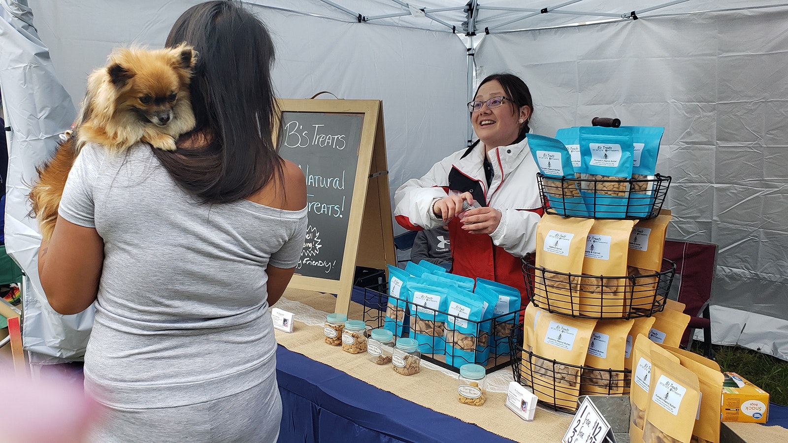 Brittany A. Batchelor offers a free sample to this pet Pomeranian during the Beartrap Summer Festival in Casper. More people are working for themselves, contributing to a shortage of people to take jobs at other businesses and agencies all over Wyoming.
