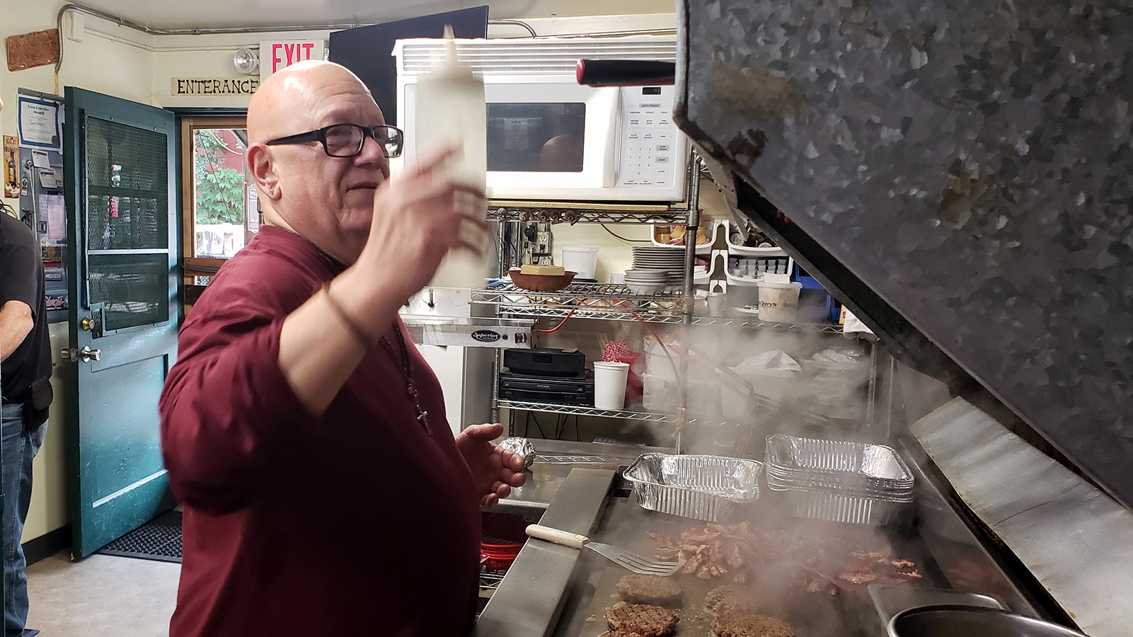 Michael Dean Coronato cooks hamburgers during the recent Sturgis Motorcycle Rally. He's been running his restaurant with what he calls a "shoestring" staff of two or three people besides himself.