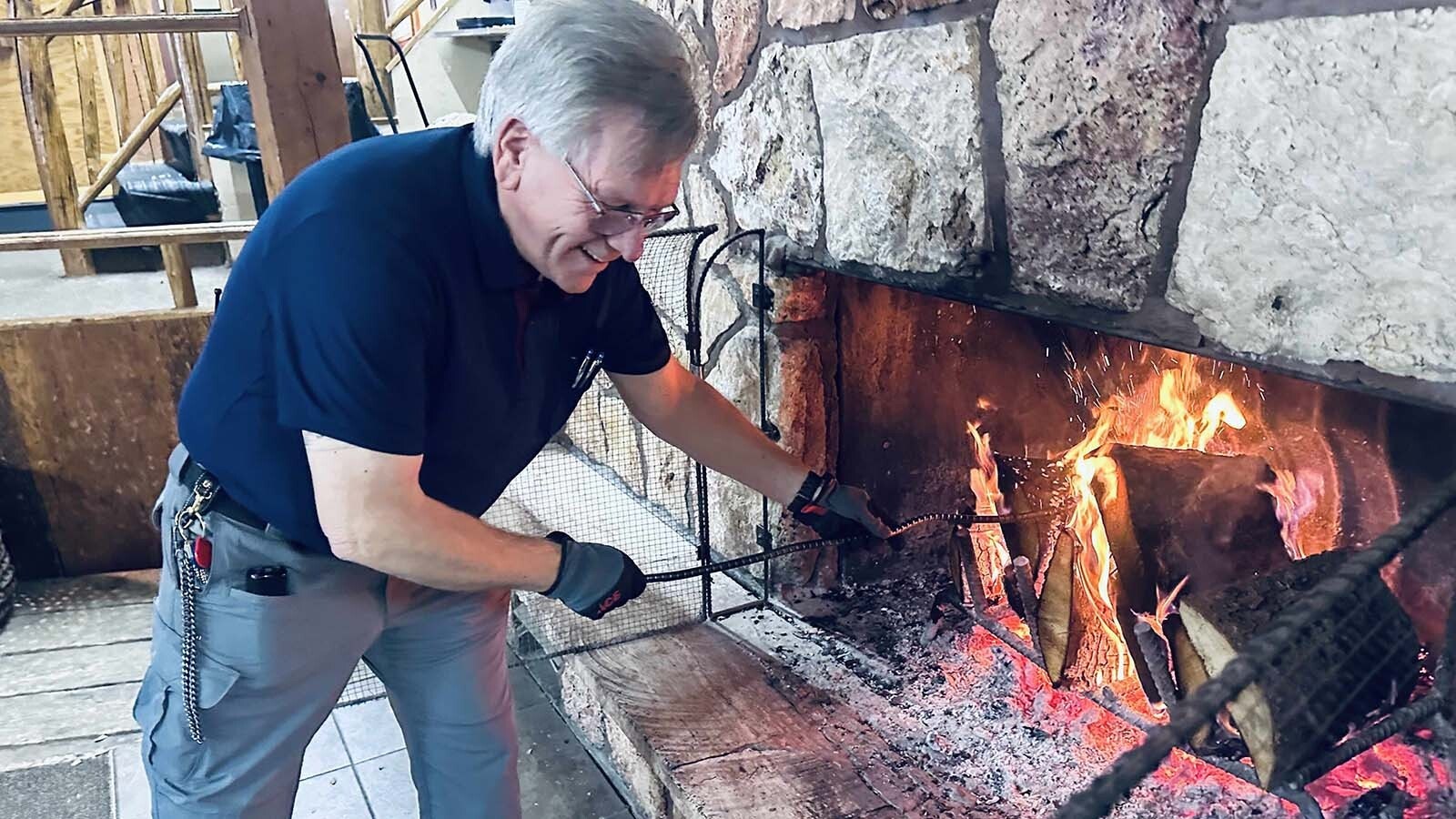 With the power out across Cooke City on Friday, Soda Butte Lodge Corporate Manager Curtis Ewers and his neighbor Michael Littlejohn stoked fires to feed and comfort snowmobilers in town.