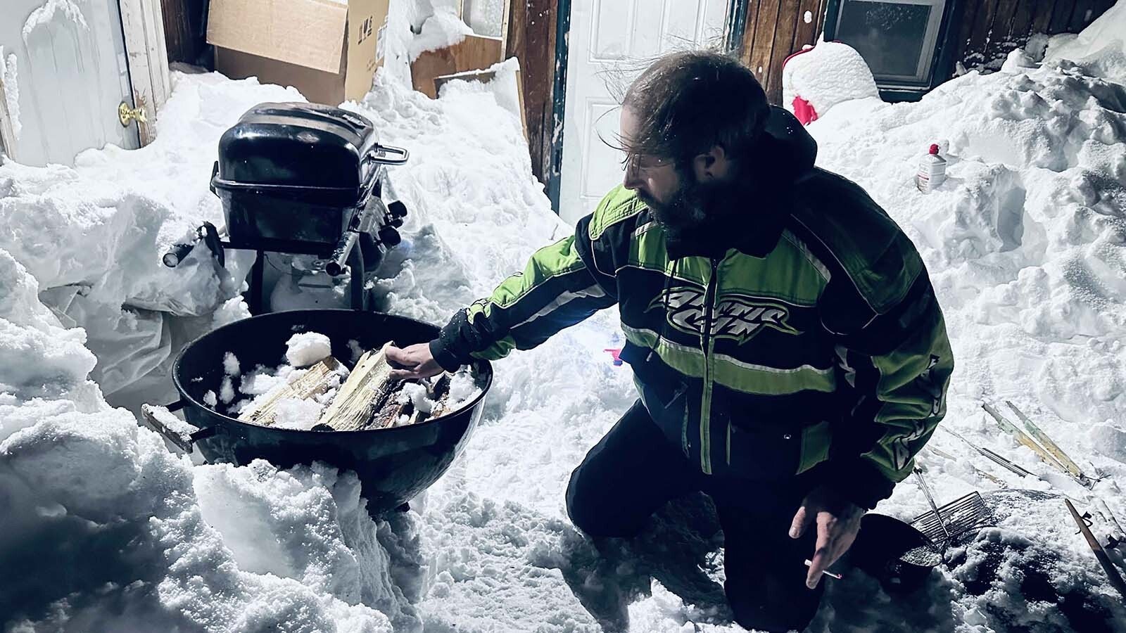 With the power out across Cooke City on Friday, Soda Butte Lodge Corporate Manager Curtis Ewers and his neighbor Michael Littlejohn stoked fires to feed and comfort snowmobilers in town.