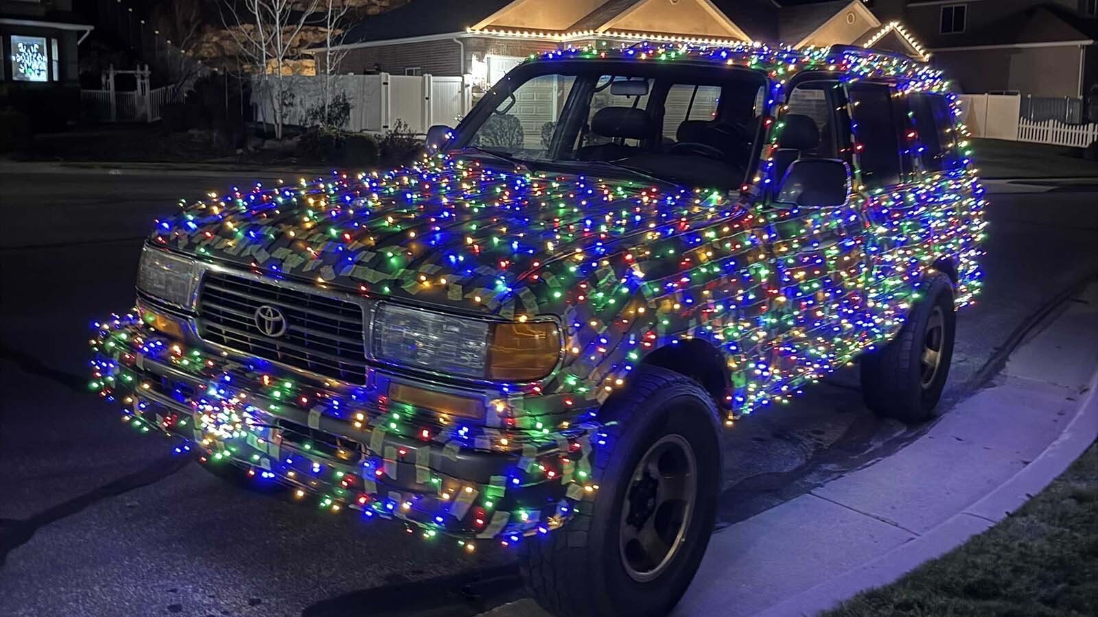 Timothy Erickson always wanted to transform his 1996 Toyota Landcruiser into a Christmas Cruiser. While driving to Mammoth Hot Springs, a wind gust busted his hood latch, so he had to strap down the hood on his yuletide 4x4.